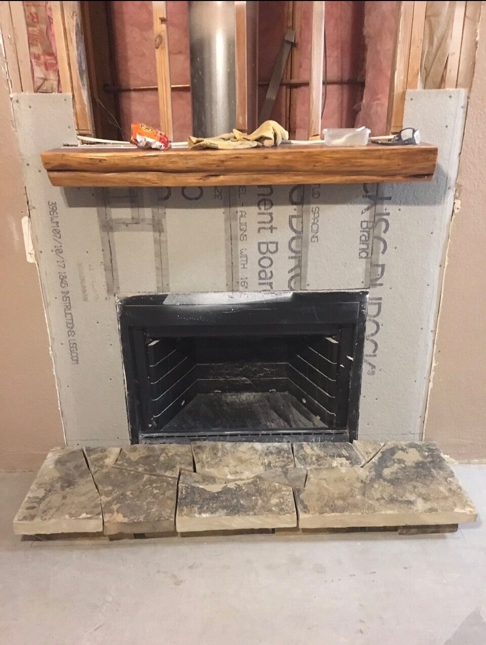 Custom fireplace with stone hearth and wood mantel