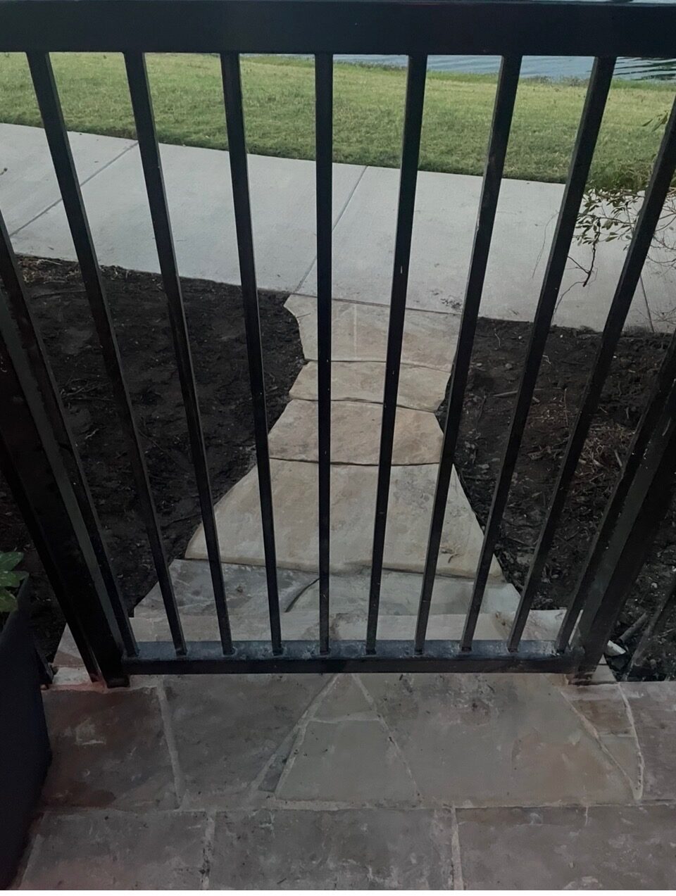 Custom iron gate cut into a fence line