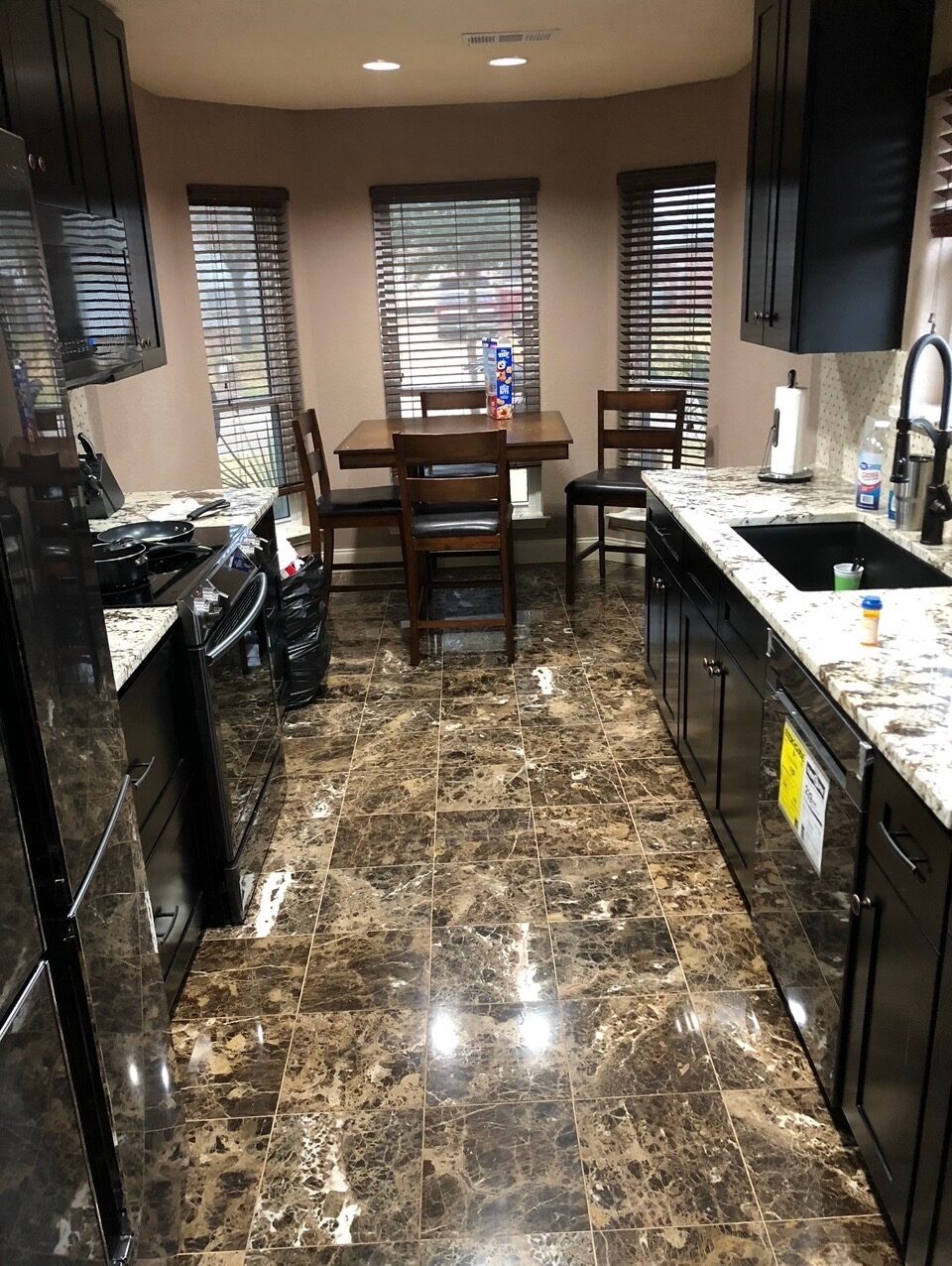 Remodeled kitchen with granite counters and dark cabinets